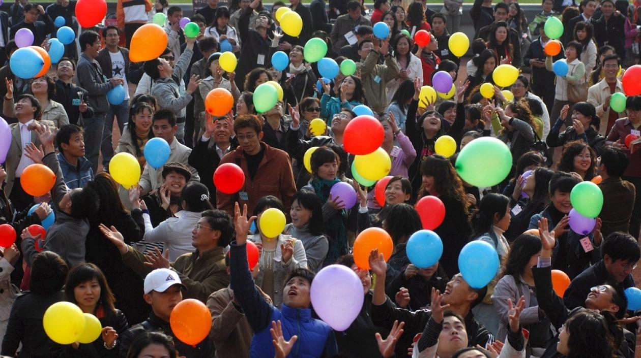  Un gran número de solteros juega con globos en una actividad para solteros, durante la conmemoración de su día, en el Estadio Qingdao, de la provincia china de Shandong.