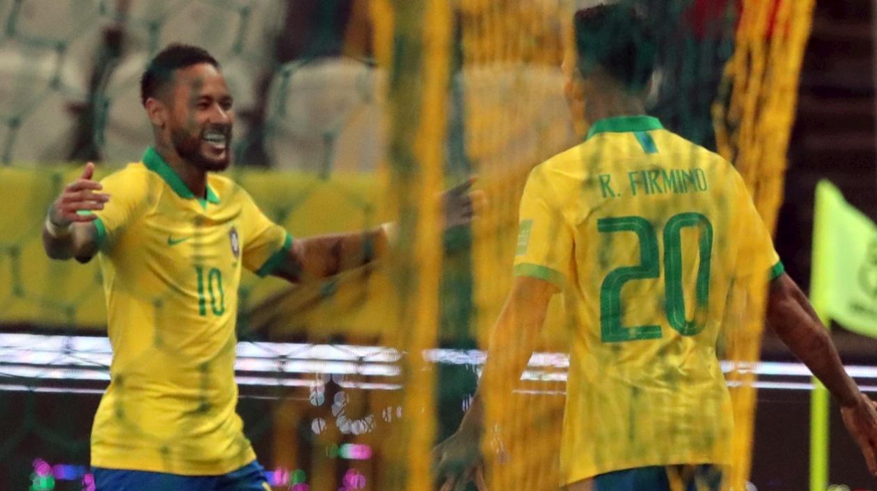 Roberto Firmino celebra un gol con Neymar