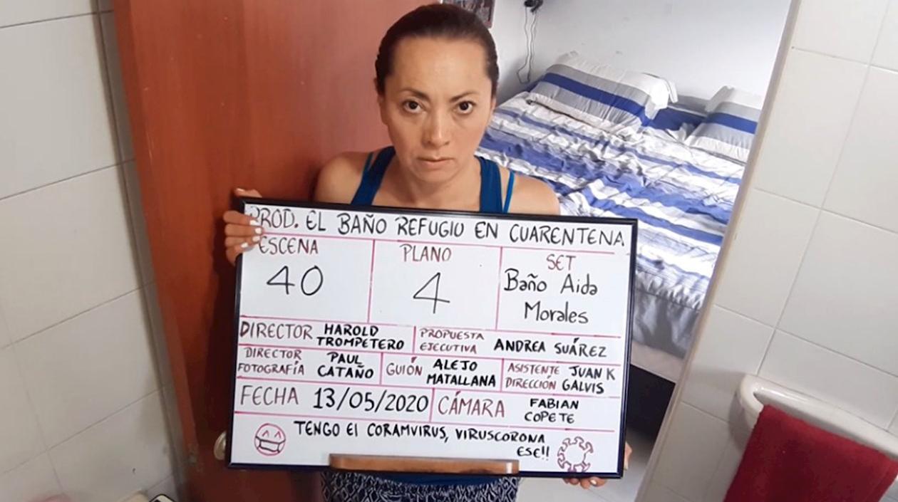 Captura de video cedido por Trompetero Producciones que muestra a la actriz colombiana Aída Morales mientras enseña los elementos con los que realiza la grabación de la película "El Baño, Refugio en Cuarentena" en Bogotá.