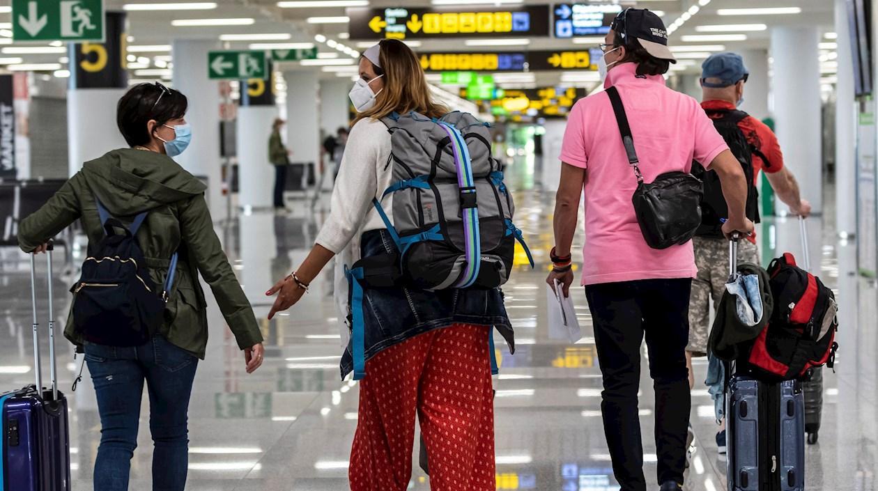Viajeros ataviados con mascarillas a su llegada al Aeropuerto de Palma de Mallorca, este domingo.