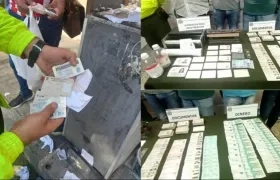 Documentos y dinero en efectivo incautados a los capturados.