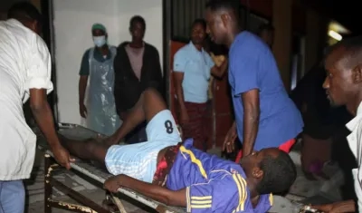 Un hombre herido es trasladado tras la explosión de dos coches bomba en Mogadiscio.
