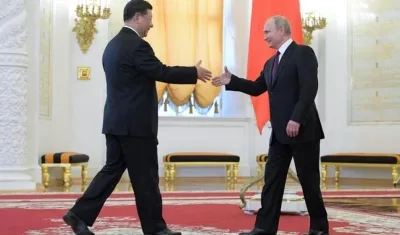 El presidente ruso, Vladimir Putin (d), saluda a su homólogo chino, Xi Jinping, durante su reunión en el Kremlin, este miércoles, en Moscú, Rusia. 