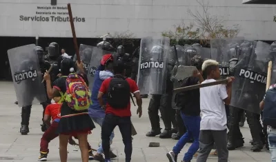 Indígenas se enfrentan durante una protesta con el Esmad de la Policía en Medellín.