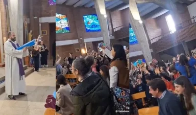 Párroco bendice a los niños de la iglesia con una pistola de agua.