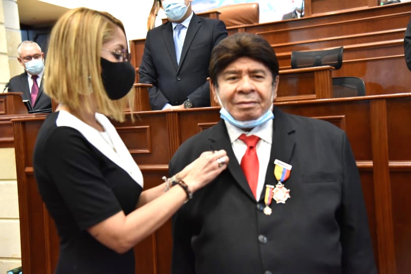 La presidenta de la Cámara Jennifer Arias también le impone condecoración.