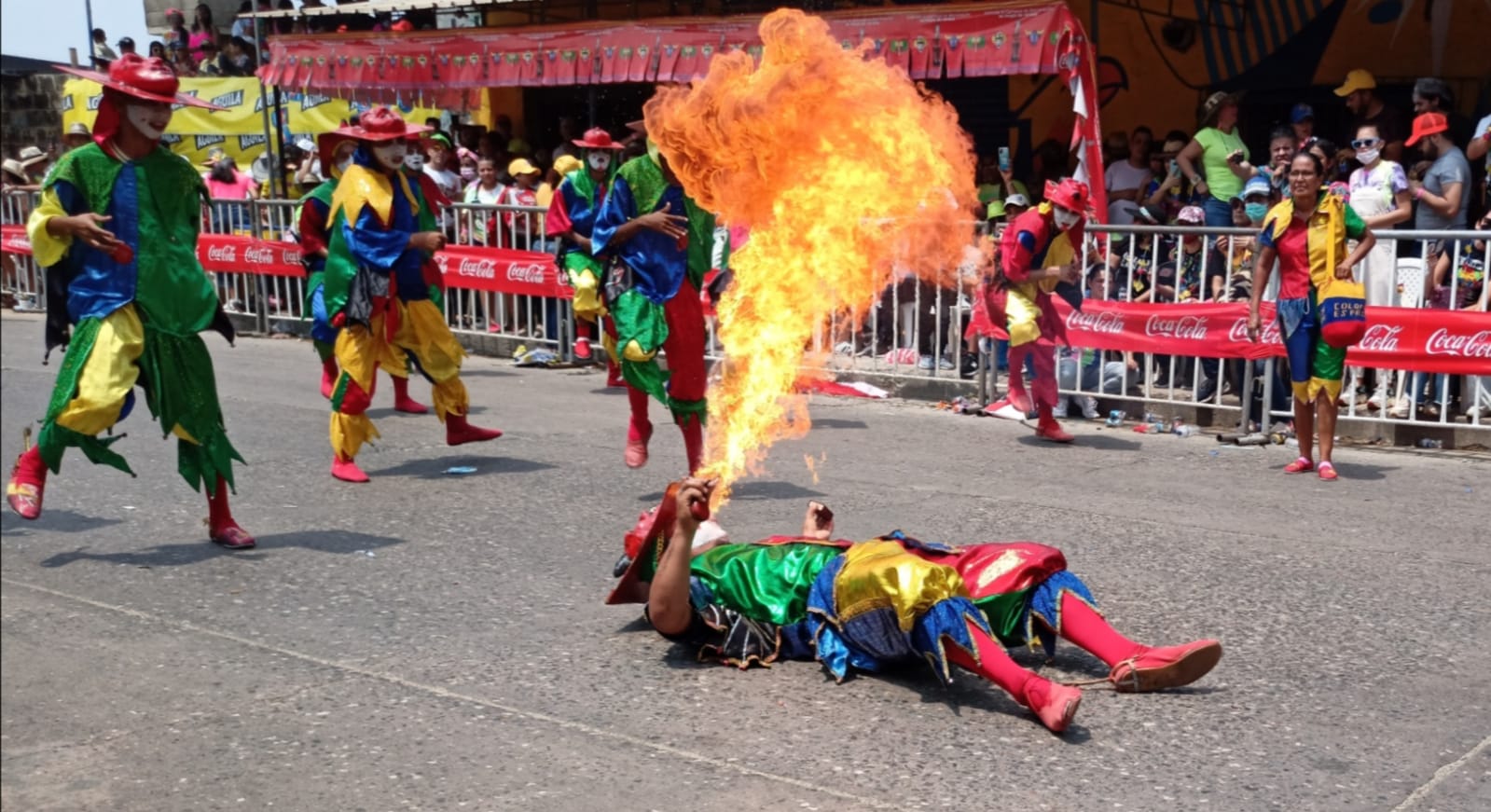 Miguel Padilla González, diablo arlequín de Sabanalarga, escupiendo fuego desde el asfalto de la Vía 40, en medio del inclemente sol.