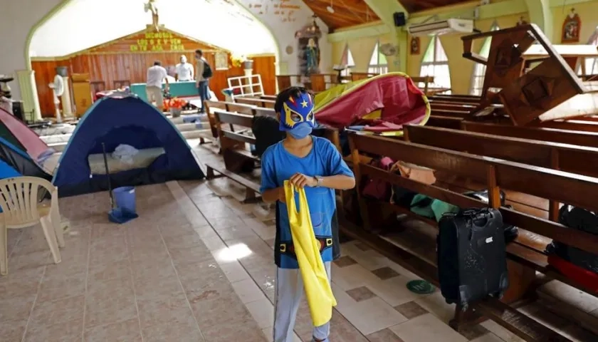 Un niño juega en una iglesia usada como albergue.