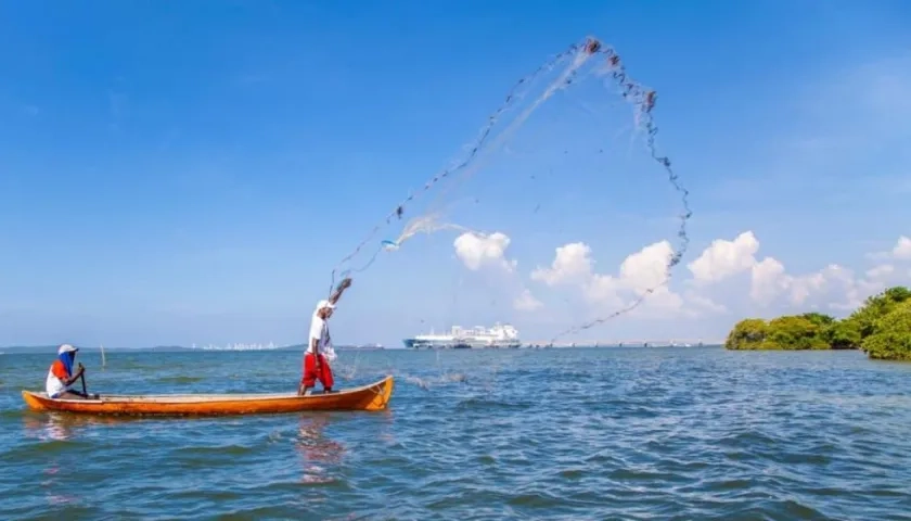 La perfecta armonía: la terminal y un pescador con su red lanzada y sostenida en el aire.