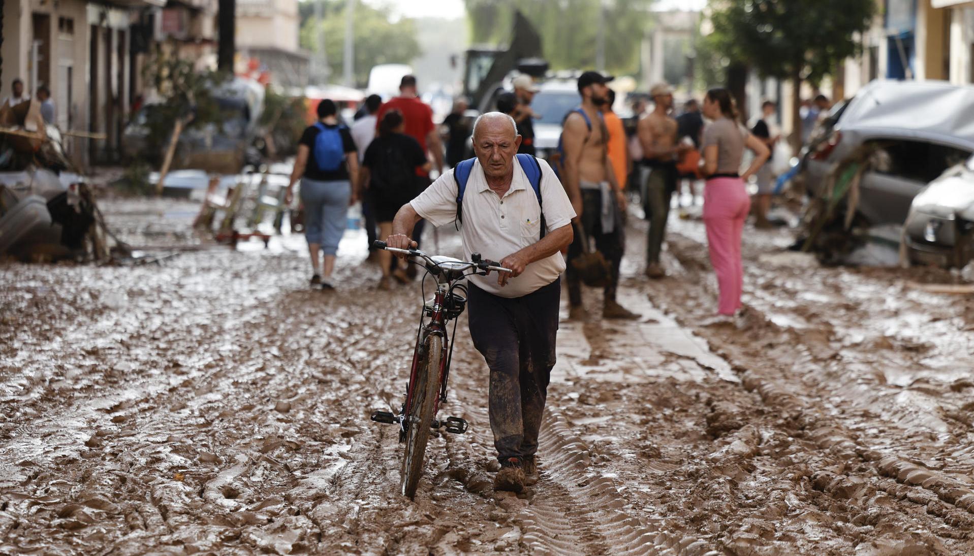 Calle cubierta de barro tras inundaciones.