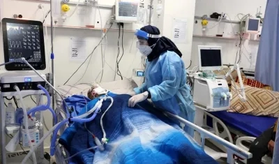 Un trabajador médico palestino revisa a un paciente en la sección Covid-19 del hospital Dura cerca de Hebrón.